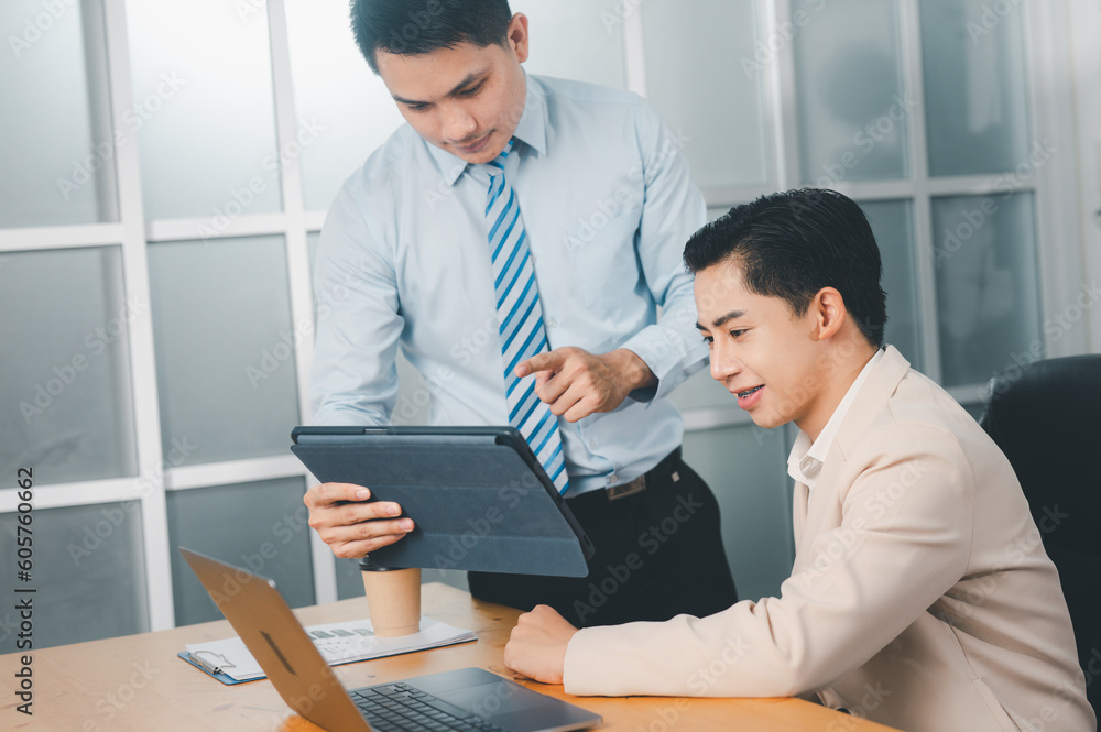 Fototapeta premium During work meetings in modern office, two business people explain statistics data to each other,Making reports, analitycs, and routine processing tasks. Concept of business