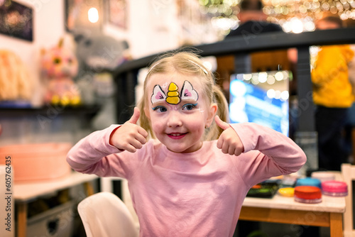 Happy little girl with  a painted face