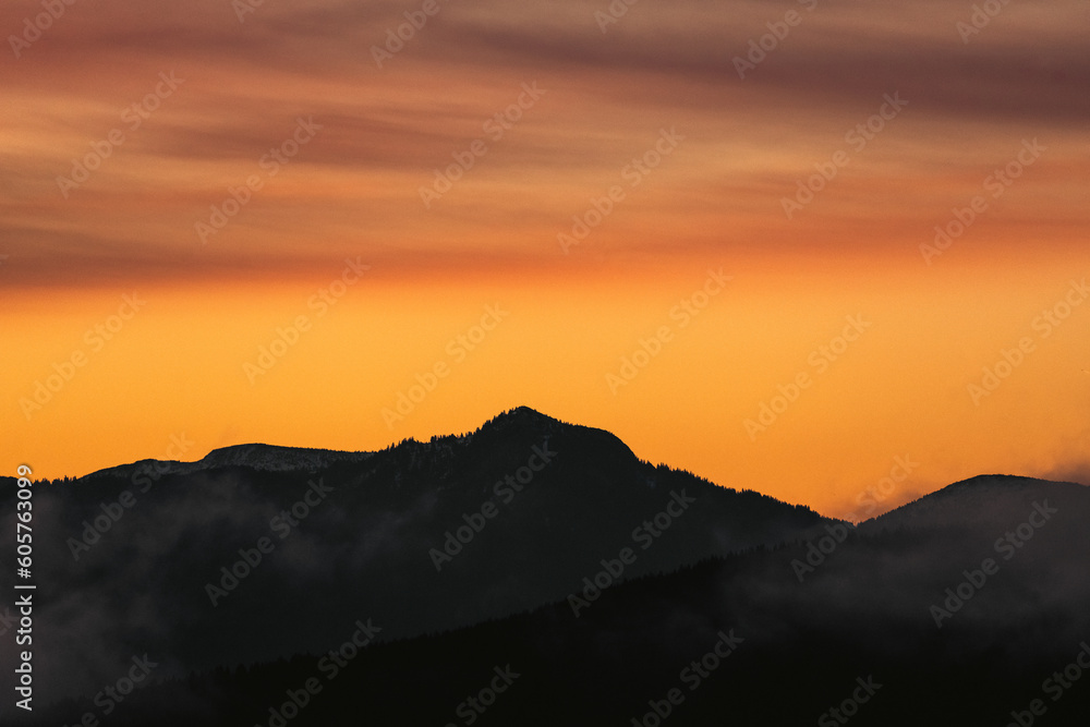 Silhouette of mountains and orange sky during beautiful sunset