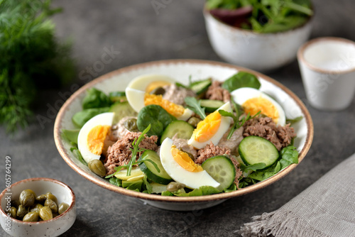 Healthy canned tuna salad with capers, egg, potato and cucumber.