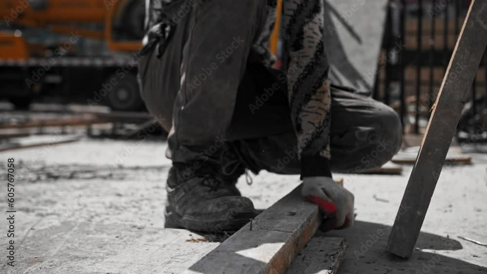worker hammers a nail with a hammer worker hammers a nail with a hammer