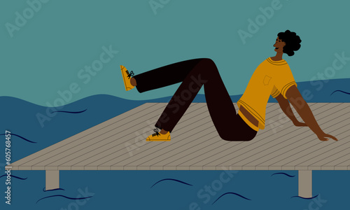 a man rests on the pier near the pond and enjoys the pleasant atmosphere