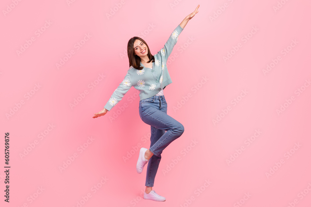 Full body photo of young flying wings hands woman wear flowers print cardigan have fun playing with kids isolated on pink color background
