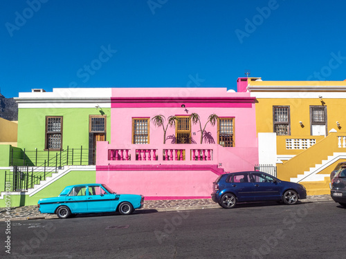 Colorful homes of Bo-Kaap in Capetown, South Africa, with deep blue sky in background.