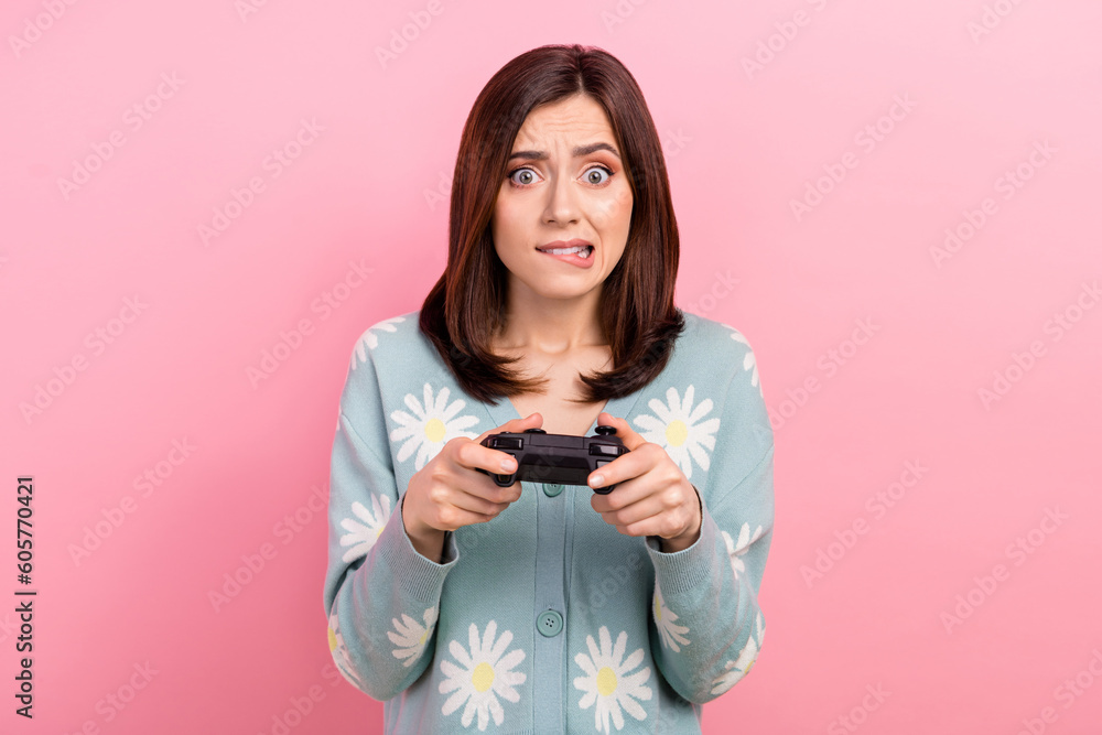 Photo of excited nervous lady wear turquoise clothes biting lip losing playstation game isolated pink color background Photo of excited nervous lady wear turquoise clothes biting lip losing playstation game isolated pink color background