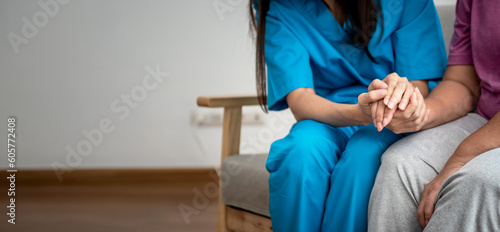 Woman doctor holding hand,  take care and encourage elderly patien, which she is saddened from depression, to elderly and  health care concept.