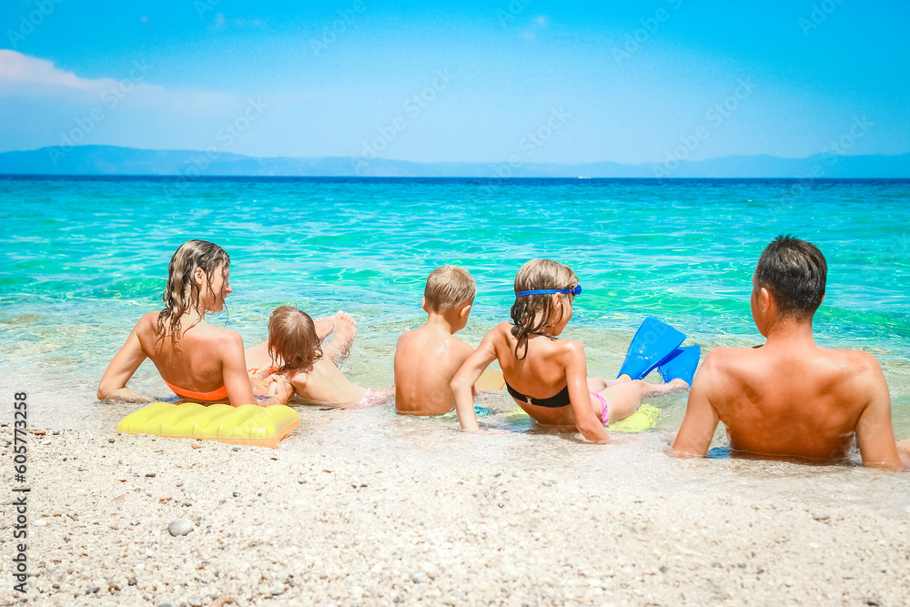 A happy family at sea in greece on nature background