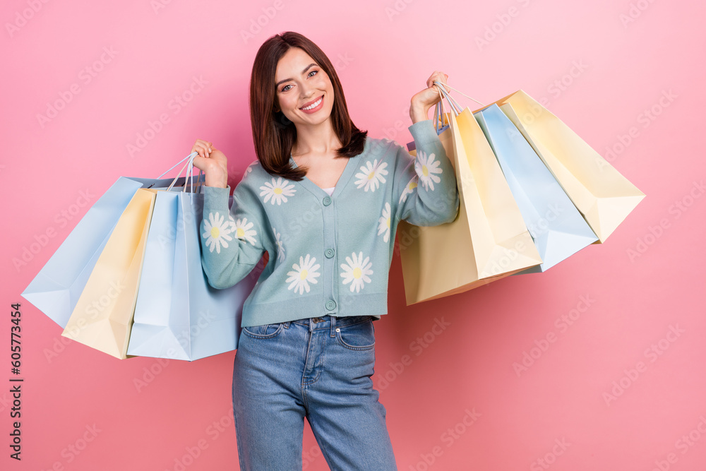 Photo of excited funky woman dressed teal outfit smiling rising bargains isolated pink color background