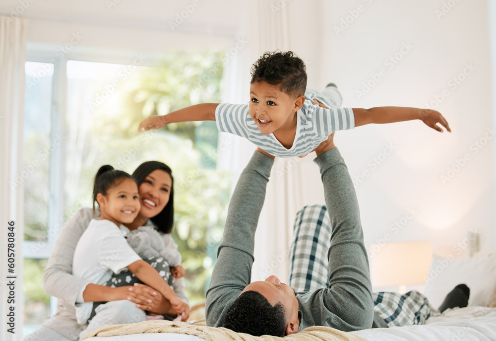 Airplane, family and father with boy, bed and happiness with bonding, loving together and laughing. Love, parents and siblings in a bedroom, brother and sister playing games, fun and weekend break