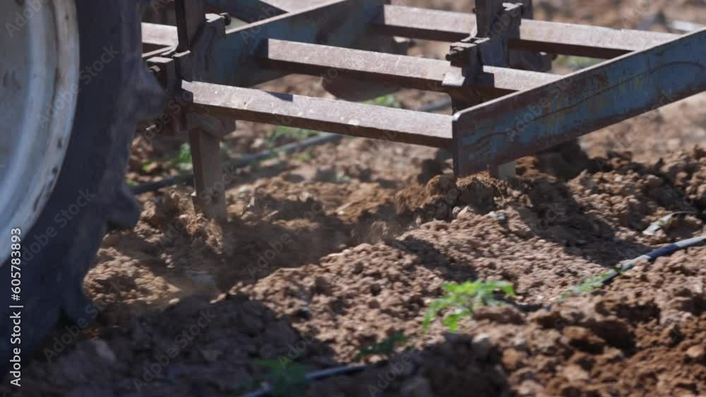 close up of soil aeration with tractor. Blades of a rototiller working the land, agriculture, slow motion close up close up of soil aeration with tractor. Blades of a rototiller working the land, agriculture, slow motion close up