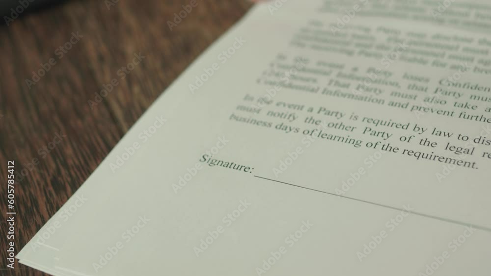 Contractor points where to put signature in the contract. Close up. Contractor points where to put signature in the contract. Close up.