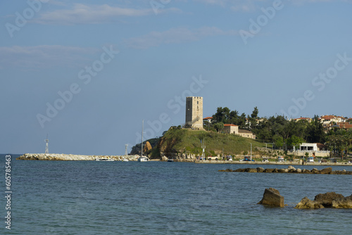 View of byzantine tower and beach of village Nea Fokea in peninsula Kassandra Halkidiki Greece