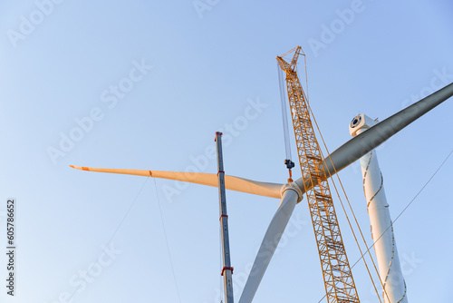 Wind turbines being hoisted and under construction