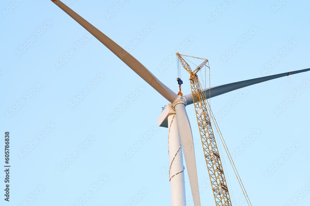 Fototapeta premium Wind turbines being hoisted and under construction
