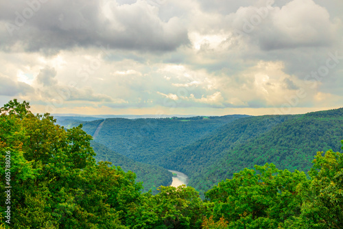 Looking over a mountain vista with lots of stormy grey clouds in the sky.