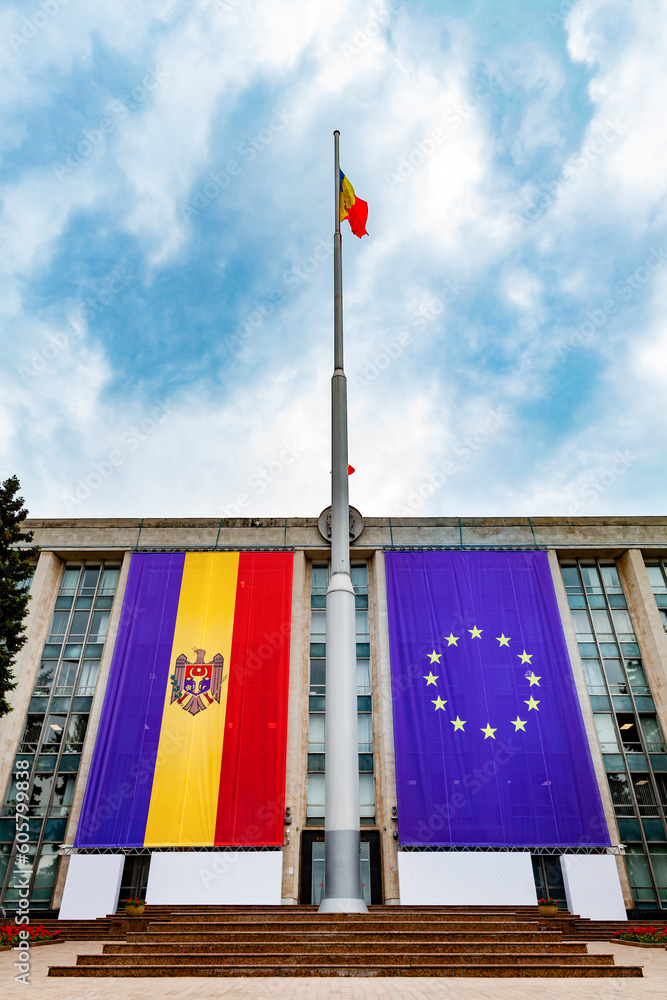 Large flags of the Republic of Moldova and the European Union on the building of the government of Moldova on the eve of the summit of the European Political Community