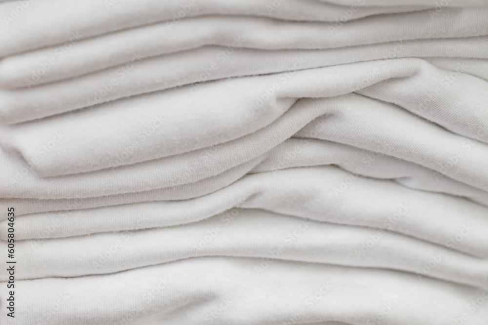 Woven products made of light fabrics are stacked in close-up, selective focus . Woven products made of light fabrics are stacked in close-up, selective focus .