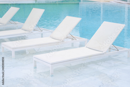 Chairs in swimming pool at luxury hotel, Summer vacation at poolside © 1st footage