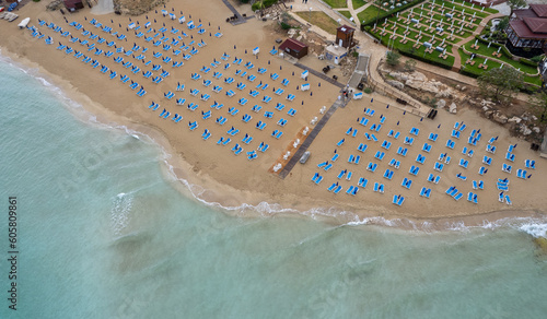 Drone aerial of beach chairs in a tropical sandy beach. Summer holidays in the sea. Protaras Cyprus photo