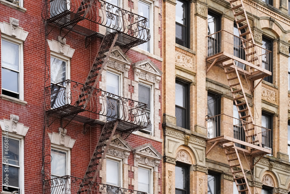 Beautiful classic New York City apartment building exterior with ornate window details and fire escapes