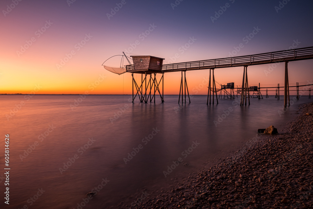 Fishing hut on stilts coast of Atlantic ocean at sunset near La Rochelle, Charente Maritime, France