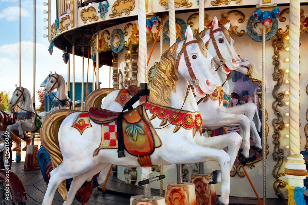 A carousel with beautiful white horses.  Festival