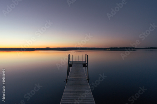 calm lake at sunset with jetty