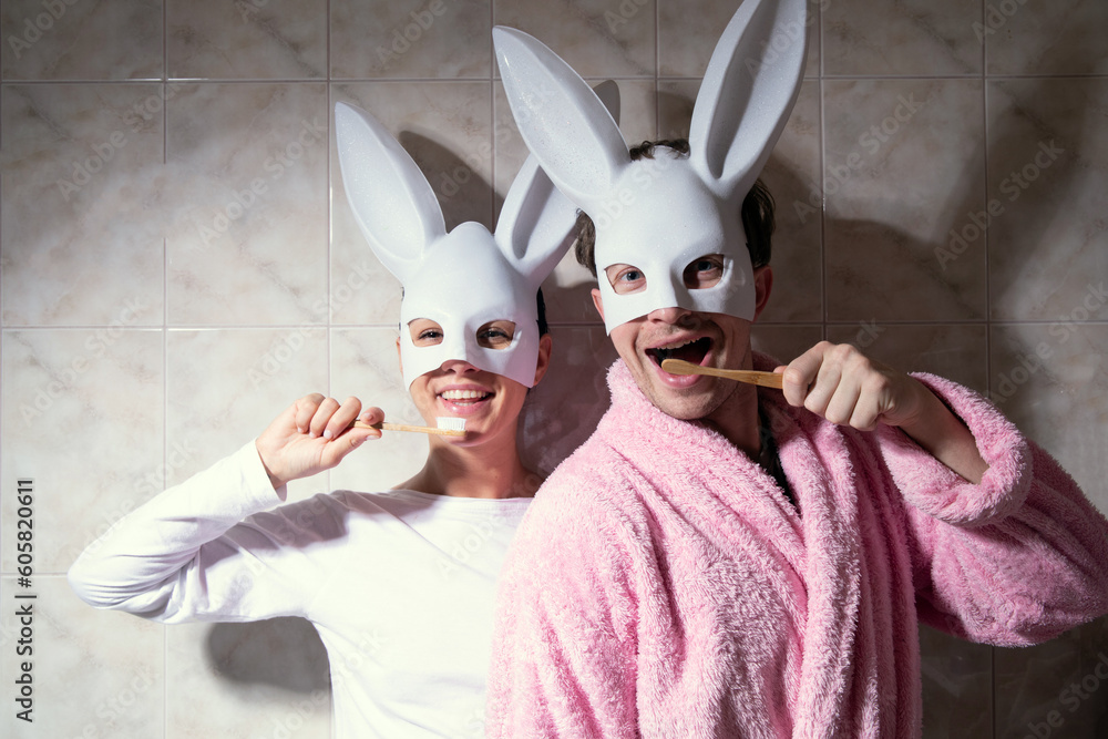 Φωτογραφία Smiling young loving Caucasian couple look in mirror enjoy daily morning routine