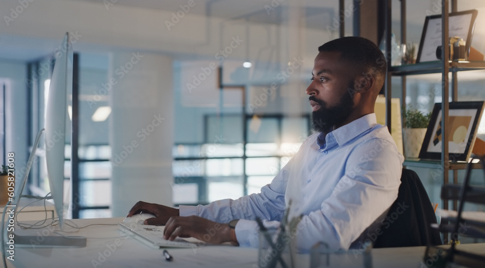 Business man, focus and working on a computer at night while typing an email or report. A serious black male entrepreneur with technology for networking, internet connection and online research Business man, focus and working on a computer at night while typing an email or report. A serious black male entrepreneur with technology for networking, internet connection and online research