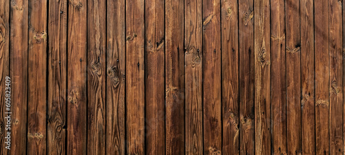 Wall of dark wooden planks in the background of a rural house. wood texture