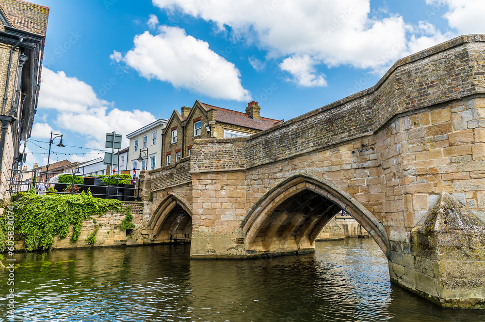 A view looking up at the medieval footbridge over the  River Great Ouse in St Ives, Cambridgeshire in summertime