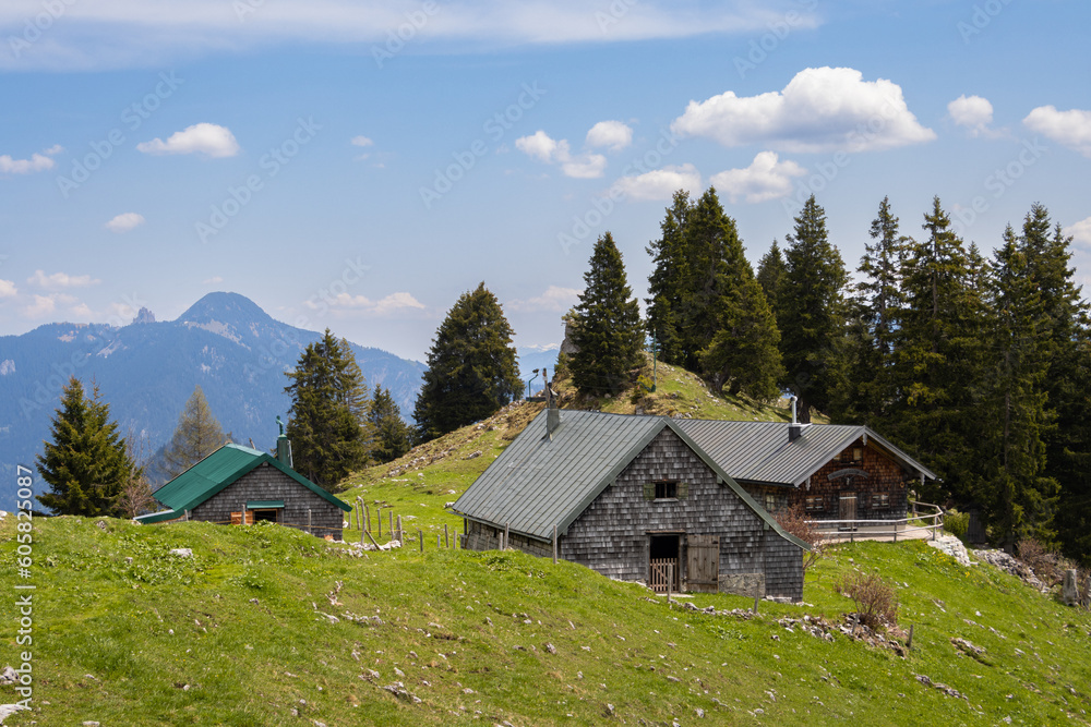 Wooden cabins on grassy pastures in the Bavarian mountains