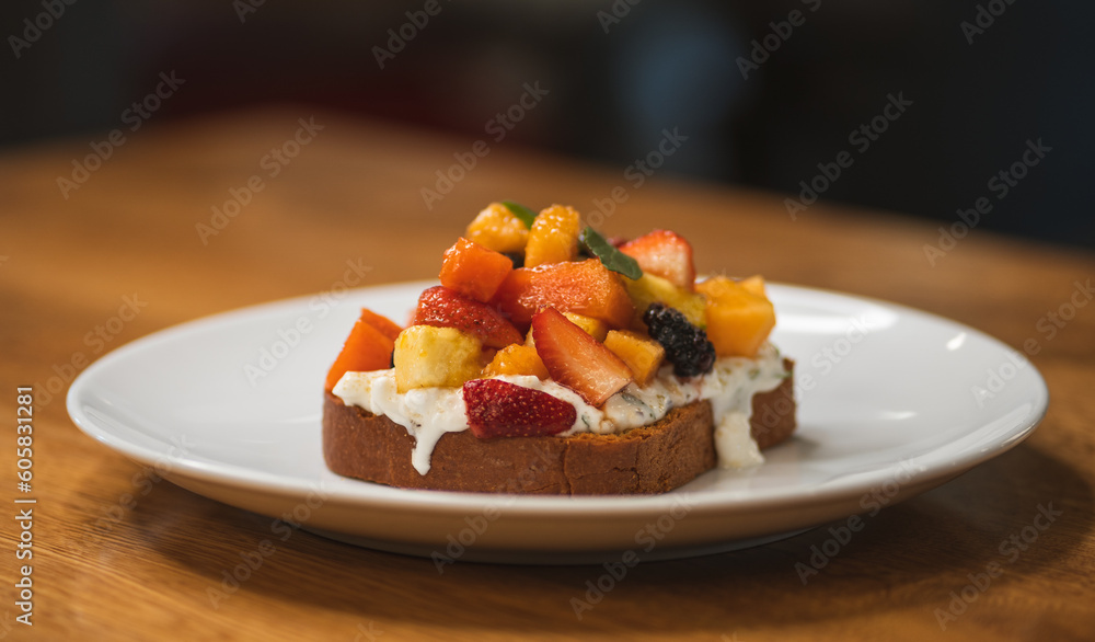 Fresh combination of fruits on brioche bread accompanied by cottage cheese Fresh combination of fruits on brioche bread accompanied by cottage cheese