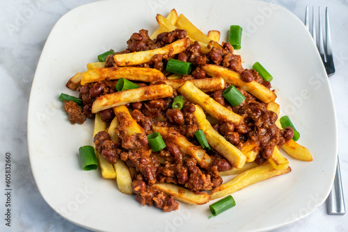  french fries top with  chilio and green onions