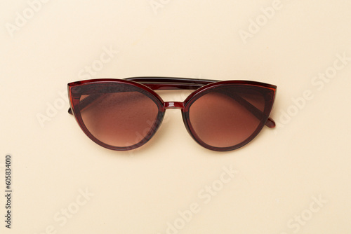 Sunglasses on color background, top view. © Liami