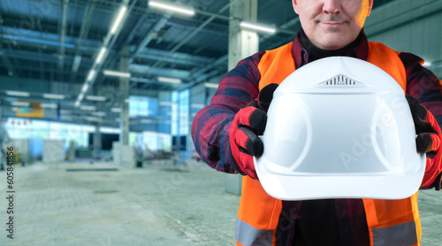 Helmet in builder hand. Man...