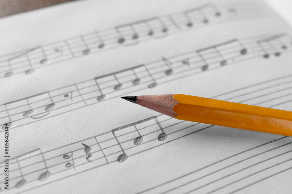 Sheet with musical notes and pencil, closeup view Sheet with musical notes and pencil, closeup view