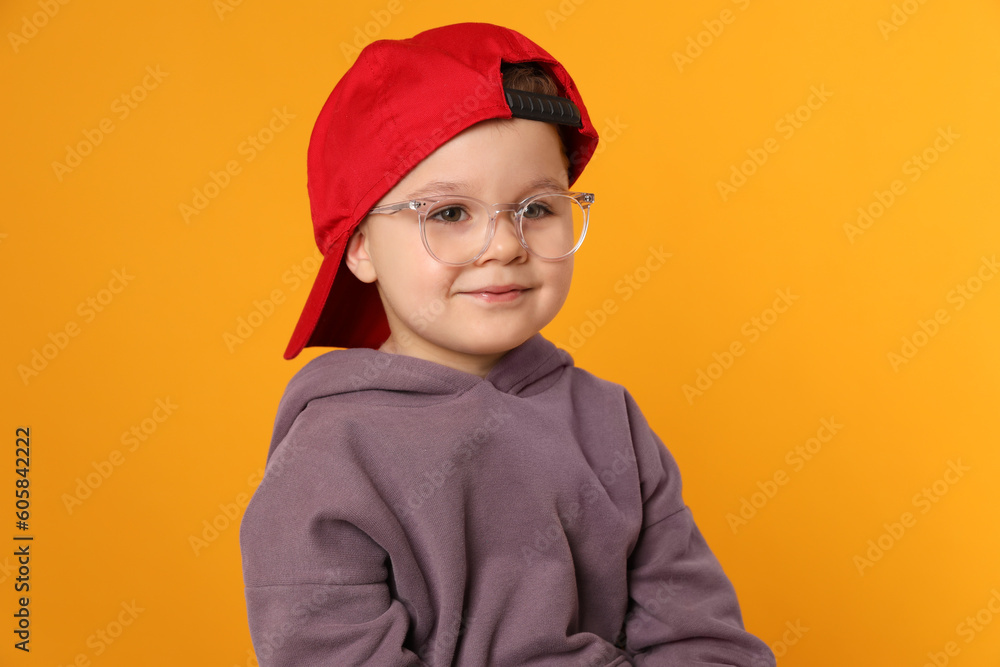 Cute little boy in glasses on orange background Cute little boy in glasses on orange background