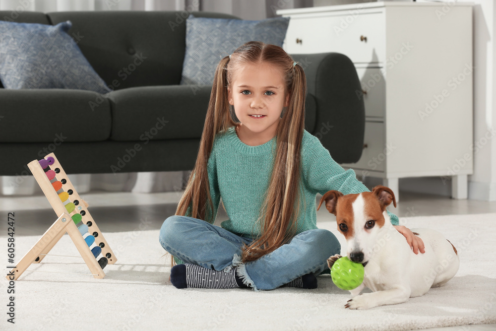 Cute girl playing with her dog on floor at home. Adorable pet Cute girl playing with her dog on floor at home. Adorable pet