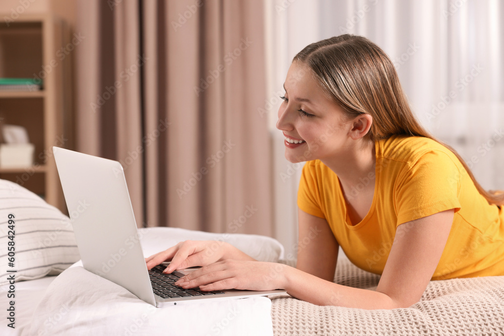 Online learning. Teenage girl with laptop on bed at home Online learning. Teenage girl with laptop on bed at home