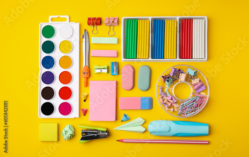 Many different school stationery on yellow background, flat lay. Back to school