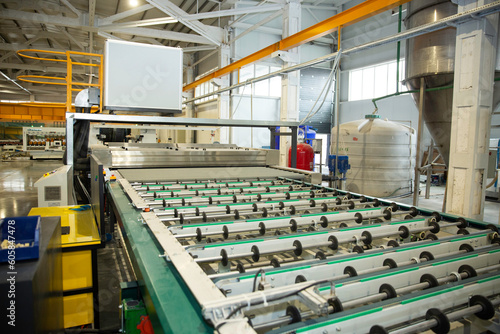 machines working with giant glasses in industrial glass window production factory. 