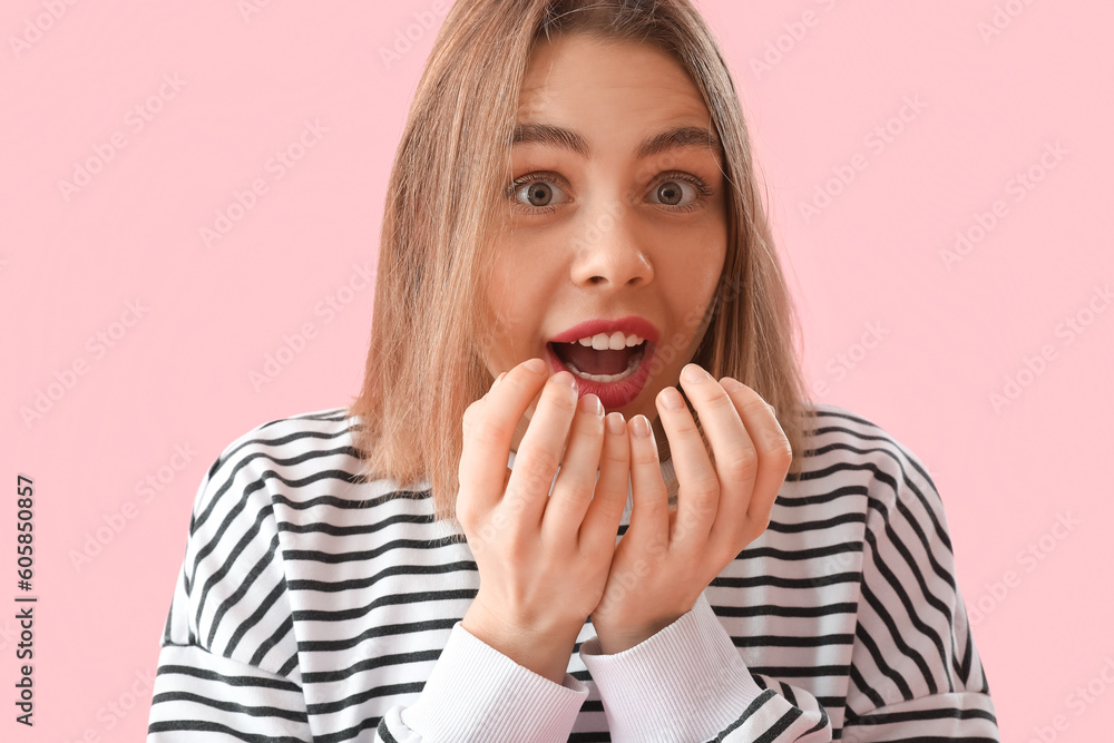 Surprised young woman in striped sweatshirt on pink background, closeup Surprised young woman in striped sweatshirt on pink background, closeup