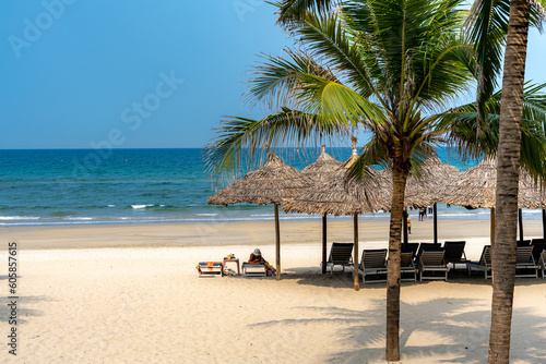 Fototapeta Naklejka Na Ścianę i Meble -  Umbrellas for tourists on the white sand beach at Da Nang city beach, Quang Nam Province, Vietnam