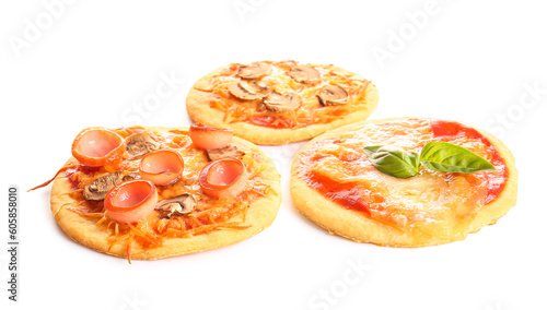 Different tasty mini pizzas on white background