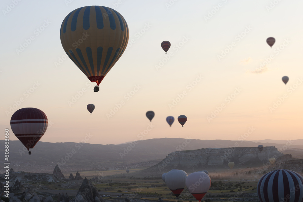 Colorful hot air balloons floating in air at bright sunrise