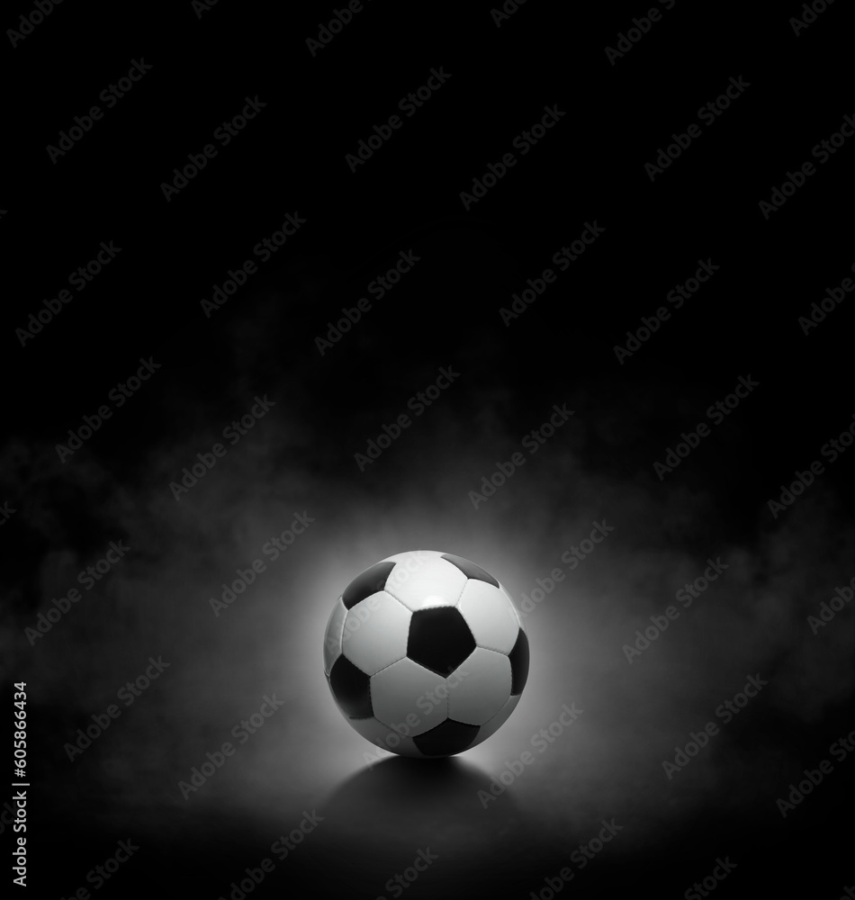 Soccer ball with on black background with smoke