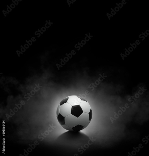 Soccer ball with on black background with smoke © Retouch man