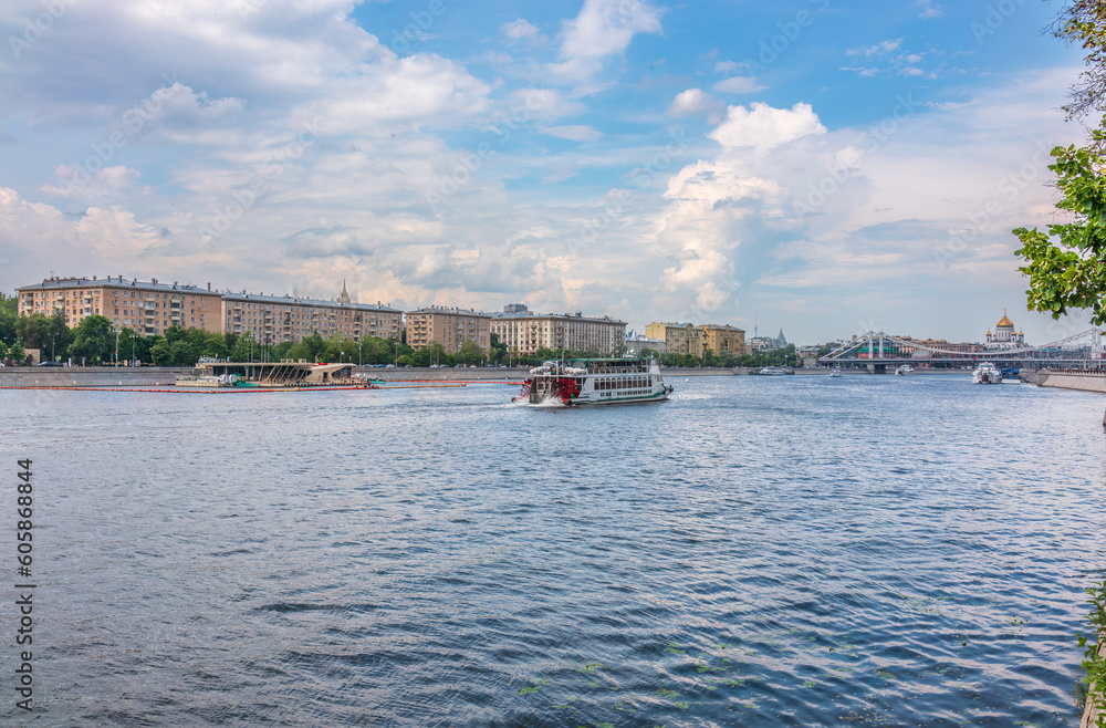 Cruise ship sails on the Moscow river in Moscow city center, popular place for walking.