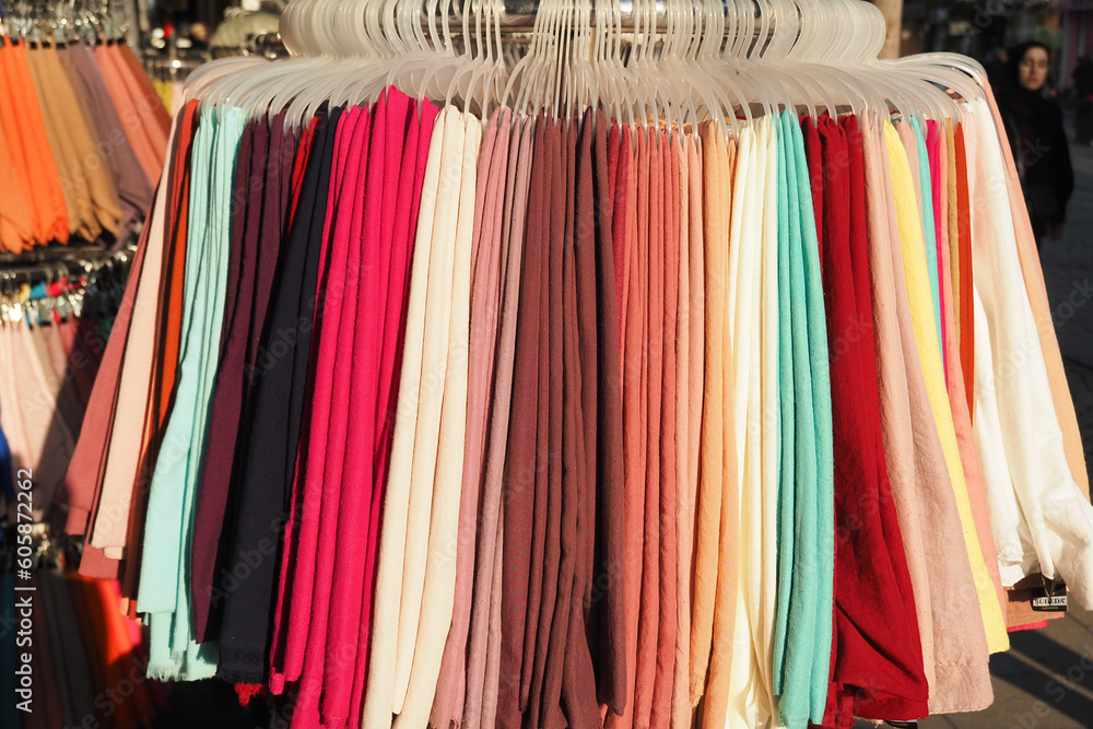 close up of stack of clothes hanging 